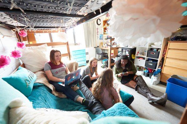 UW-La Crosse students lounge in a residence hall room.