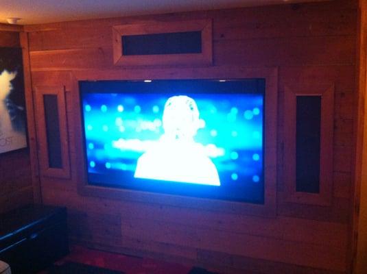 Flat screen monitor installed on full motion mount with surround sound in an underground theater in Oakland, CA.