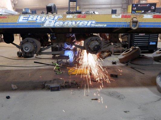 Maine Trailer service mechanic performing a suspension replacement.