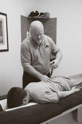 Dr. Harrington using the Activator on a patient to provide a low force, precise adjustment