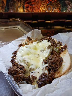 Philly beef steak with onions and peppers with provolone cheese.