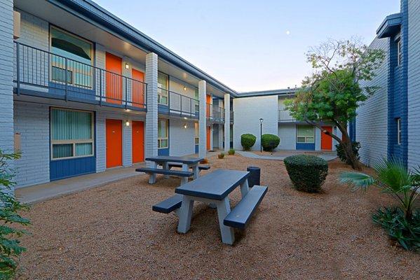 Gravel Area with Two Picnic Tables in a desert-style gravel area in between apartment buildings