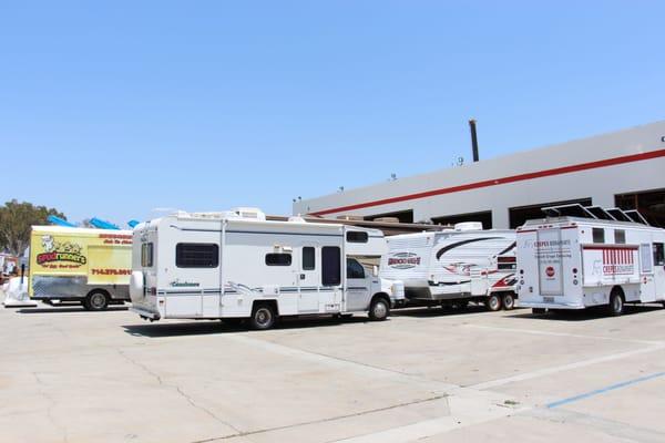 A view of RVs and food trucks being serviced