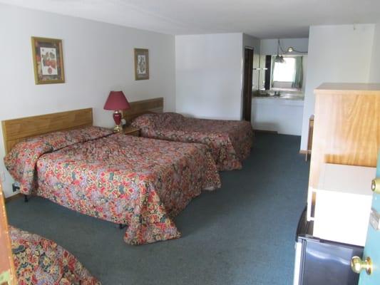 Three bedded room with TV (cable), mini-fridge, microwave, desk and chairs. Oversized vanity with coffee machine and coffee.