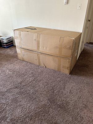 A huge couch sized box in a living room