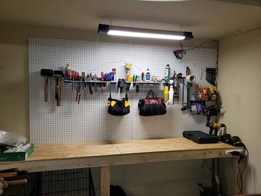 Custom workbench with tool shelf install,  organized tools and installed pegboard