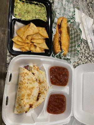 Brisket sandwich, chips/guacamole, brisket taco and chicken taco