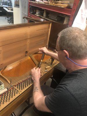 Ron stringing a piano