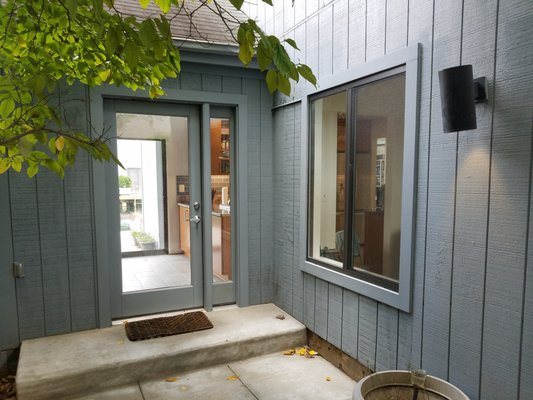 Jim Neill's house: view of patio showing new kitchen door and dining room windows which replaced a sliding glass door.