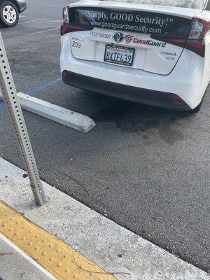 Horrible parking job illegally in handicap parking of hospital hired to "guard"