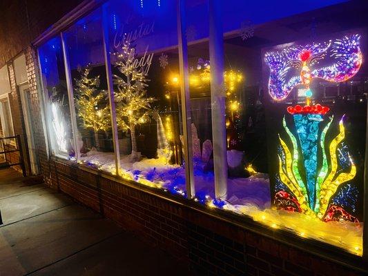 Lighted up crystal sign in windows of the shop