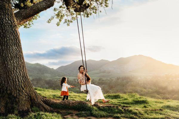 mama and toddler swing from a hidden tree swing in the east bay