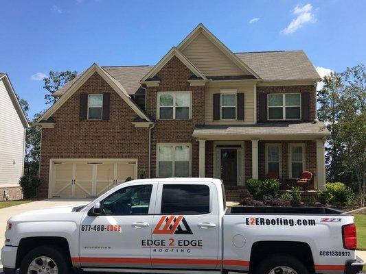 Inspecting another roof for storage damage from high winds