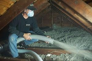 Blown in insulation being applied to an attic.