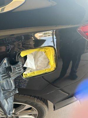 The paper and tape they didn't remove behind fuel door