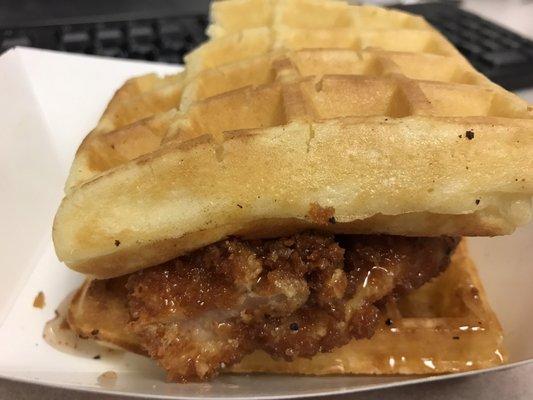 Chicken & waffle sandwich with brown sugar butter & spicy maple syrup.