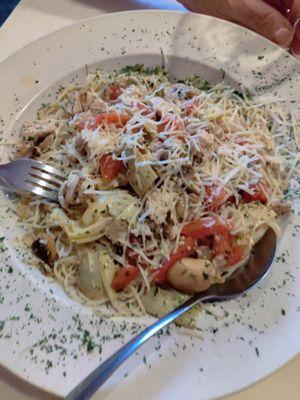 Chicken sauteed with artichoke and tomatoes over angel hair pasta