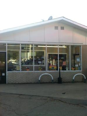 This is a nice gas station. To the right of this photo there are some pleasant brown cows