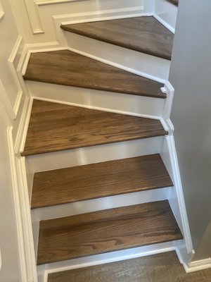 Finished hardwood flooring for stairs.