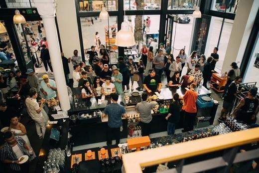 Crowd seen from above ordering at the bar inside HOMETEAM SEATTLE.