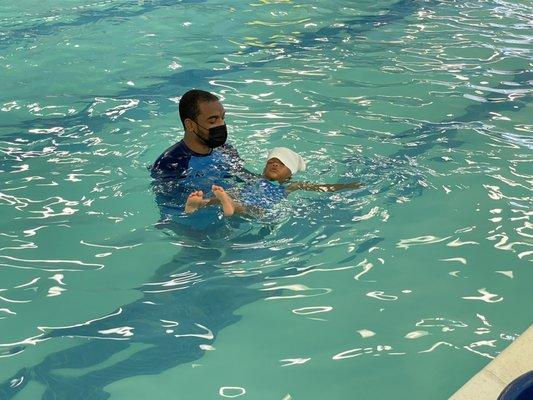 My almost 2 year old floating on her back by herself with coach Reggie