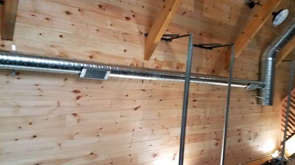 Spiral ductwork in a post & beam residential garage.