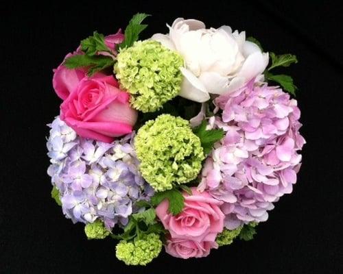 Spring arrangement with roses, hydrangeas and other spring time flower