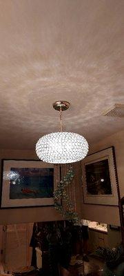 Hanging used chandelier replacement in bathroom