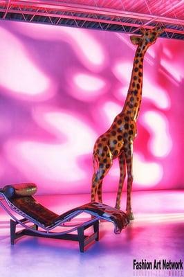 Subject: 12ft. hand carved giraffe from African wood and a Le Corbusier Chaise Lounge in Pony hair. Contact us for pricing.