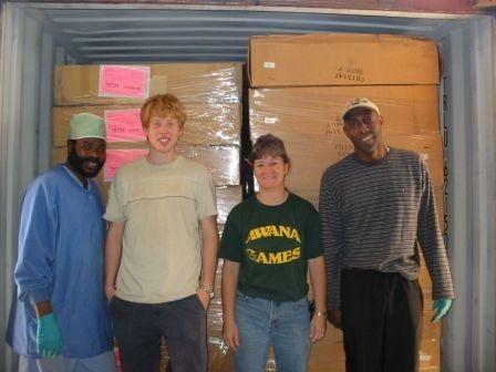 They're standing in front of a 40 foot container full of reclaimed medical supplies that was requested by a clinic in Liberia.