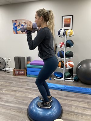 Ashley working on the Bosu Ball while singing to her little buddy, Chase