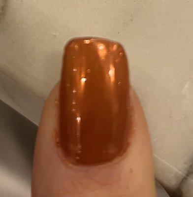 Uneven nails, clearly no rounded edges or oval shape, and polish not removed along the sides