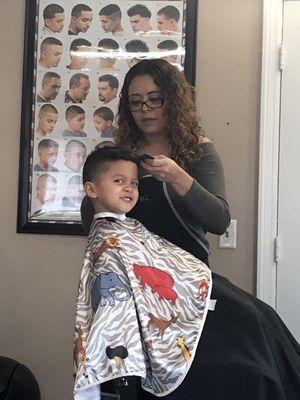 A kid getting a nice haircut.  Love this place