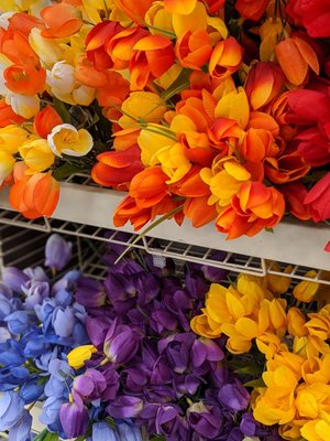 Artificial seasonal flowers near the front of the store.