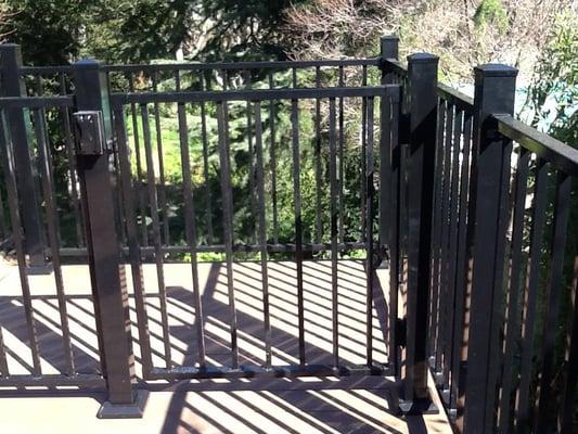 Gate at landing at top of stairs with latch, lock and key and switch for stair lights