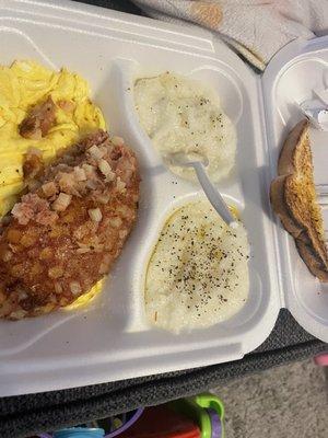 Two egg breakfast with corned beef hash and grits with toast