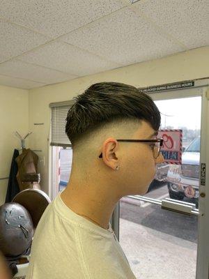 High fade with long hair on top trimmed with scissors