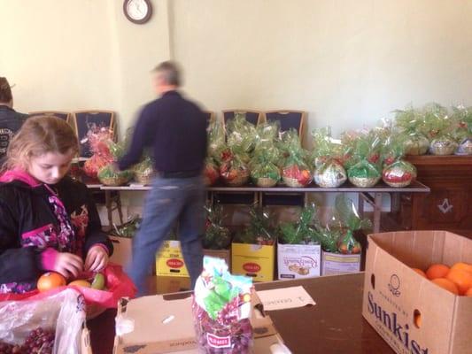 Assembling holiday fruit baskets for Widows & Retirees.