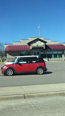 A mini car in front of the Big & Tall Outlet