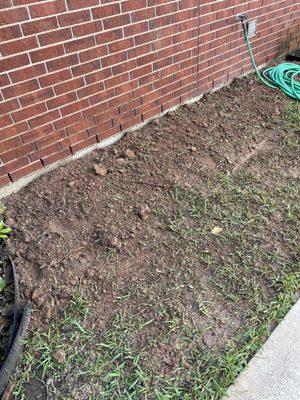 Side of house. Left bunch of dirt on top of lawn.  Said it will settle but it's still the same now.