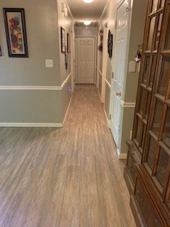 LVP Flooring installed throughout living room, hallway and kitchen.