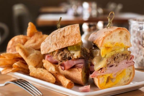 The Cuban sandwich..smoked pork, sliced ham, Swiss cheese & sweet pickles with yellow mustard on a baguette.