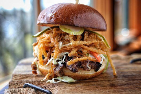 Piled high, our smoked briskets sandwich is perfect for lunch & dinner!