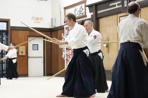 The dojo hosts many guest instructors from Aikido Schools of Ueshiba, here Josh Drachman and Tres Hofmeister practice Aiki-ken together.