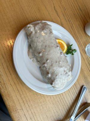 Beautiful breakfast burrito with jalapeño bacon and smothered in gravy yumm