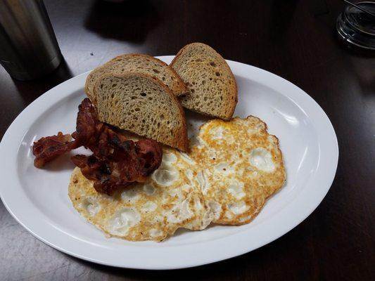 My usual, eggs over, crispy bacon and rye toast.