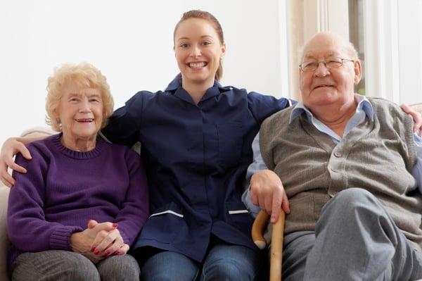 Caregiver having good time with couple in their home