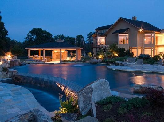 Close up of a vanishing edge pool constructed by LandArt in Easton MD.  Natural Stone Coping & Pool Decking and Outdoor Kitchen.