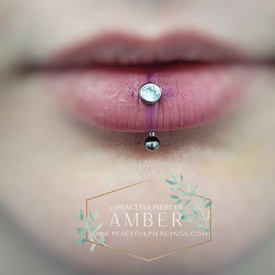 Titanium threadless barbell with bezel set CZ in fresh vertical labret