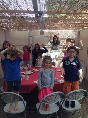 Hebrew School Students having breakfast in the Sukkah!